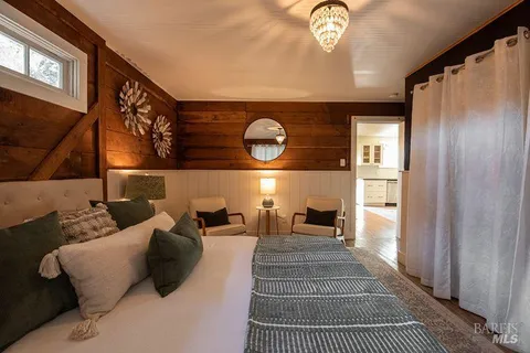 a view of a hallway with entryway wooden floor and front door