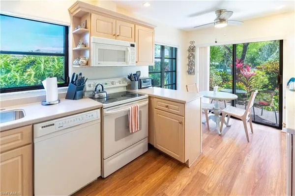 a kitchen with a sink cabinets and wooden floor