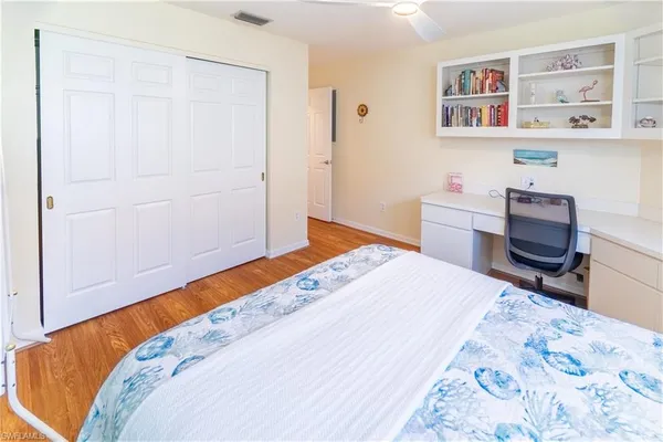 a bedroom with a bed and a dresser in it