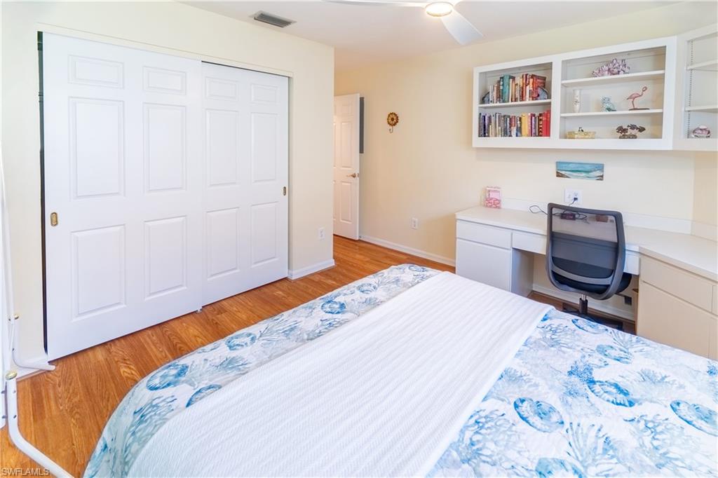 522 Beachwalk Circle Naples, FL 34108 - Photo 16 of 34 a bedroom with a bed and a dresser in it