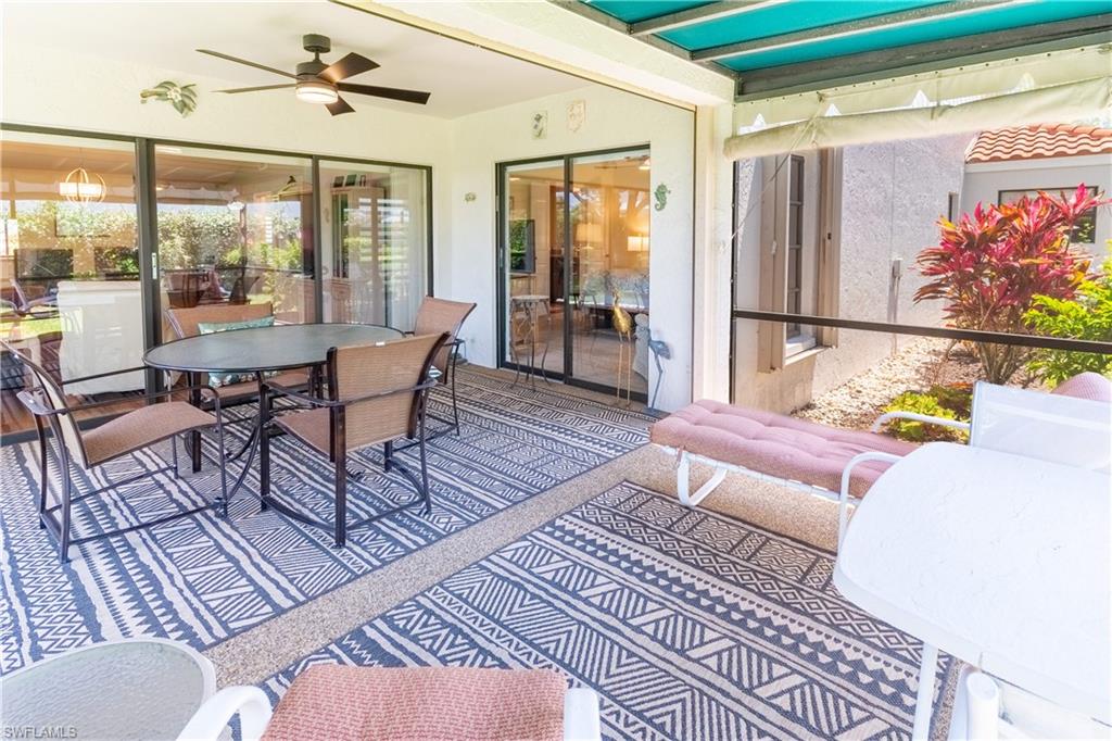 522 Beachwalk Circle Naples, FL 34108 - Photo 18 of 34 a living room with furniture and a floor to ceiling window