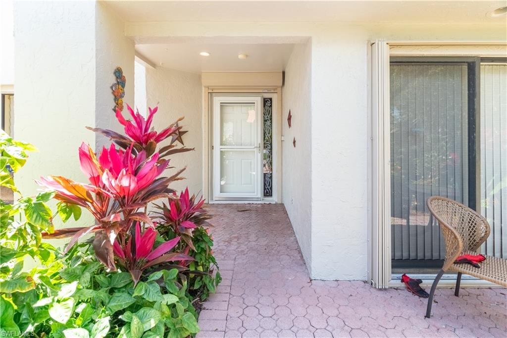 522 Beachwalk Circle Naples, FL 34108 - Photo 2 of 34 a view of a house with a backyard