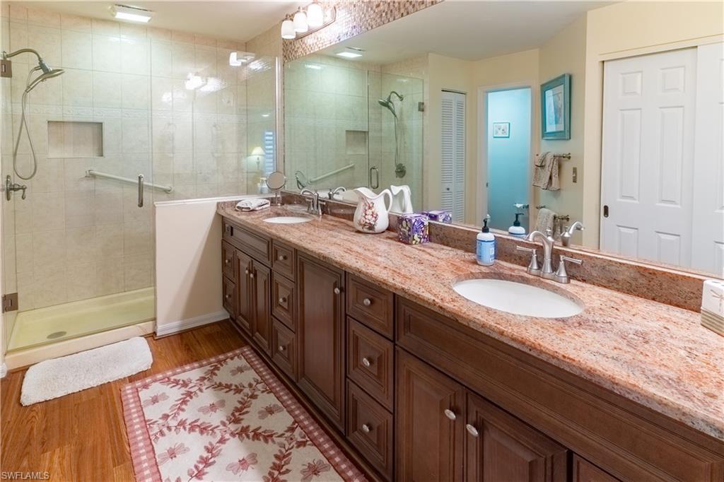 522 Beachwalk Circle Naples, FL 34108 - Photo 21 of 34 a spacious bathroom with double vanity and a mirror