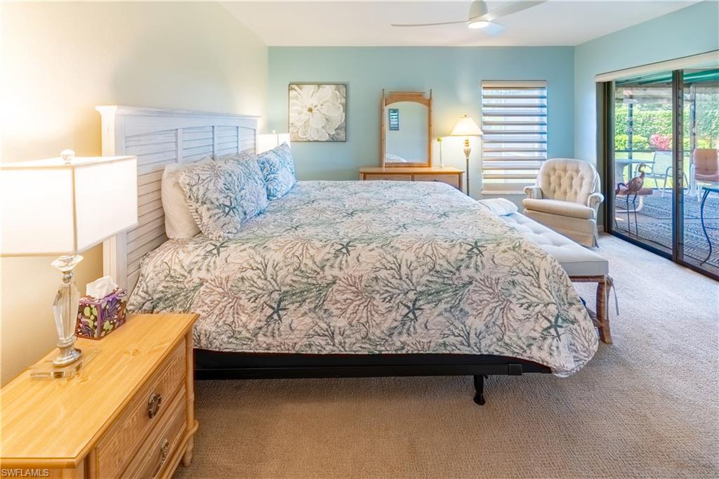 522 Beachwalk Circle Naples, FL 34108 - Photo 22 of 34 a bedroom with a bed and a window
