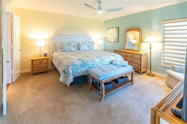 a spacious bedroom with a bed and large windows