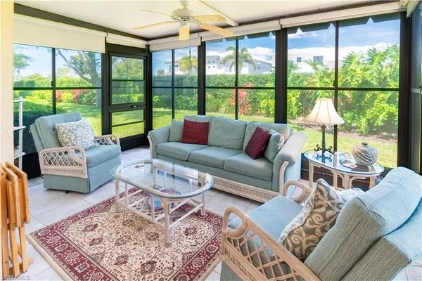 a living room with furniture and a large window