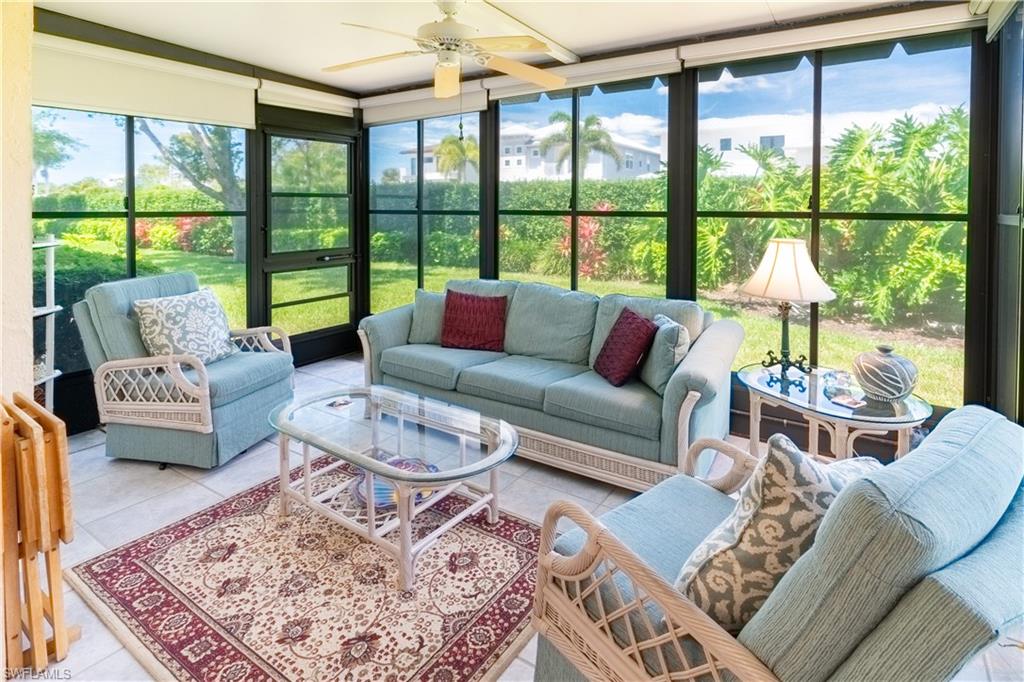 522 Beachwalk Circle Naples, FL 34108 - Photo 26 of 34 a living room with furniture and a large window