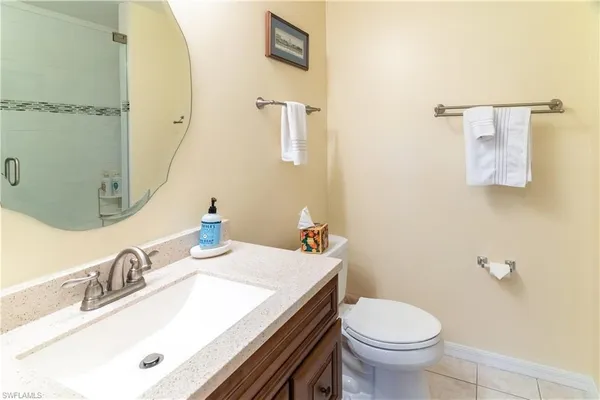 a bathroom with a sink toilet and mirror