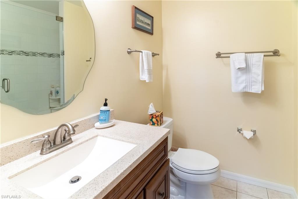 522 Beachwalk Circle Naples, FL 34108 - Photo 28 of 34 a bathroom with a sink toilet and mirror