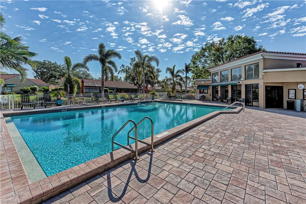 522 Beachwalk Circle Naples, FL 34108 - Photo 32 of 34 a view of a swimming pool with a patio and a yard