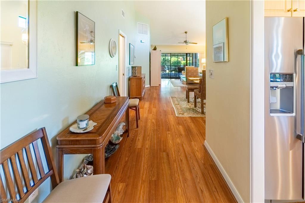 522 Beachwalk Circle Naples, FL 34108 - Photo 5 of 34 a view of a living room with furniture and wooden floor