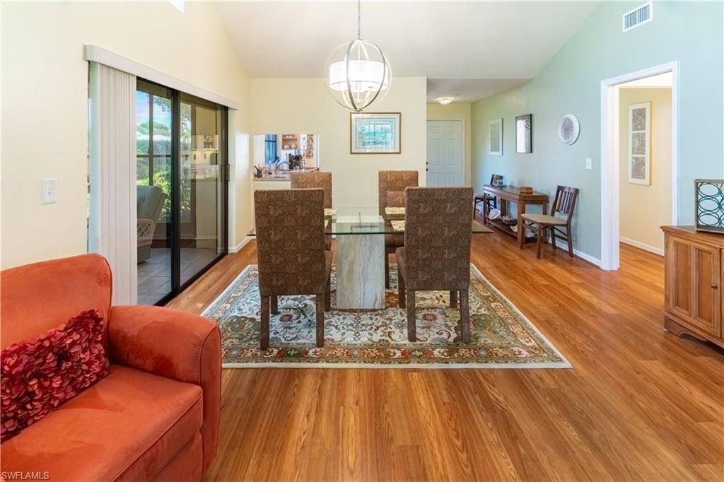 522 Beachwalk Circle Naples, FL 34108 - Photo 8 of 34 a living room with furniture and wooden floor
