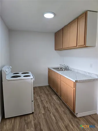 a utility room with cabinets washer and dryer