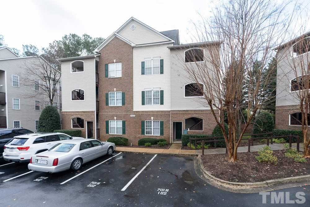 7022 Sandy Forks Road, Unit 201 Raleigh, NC 27615 - Photo 1 of 30 a front view of a house with garden
