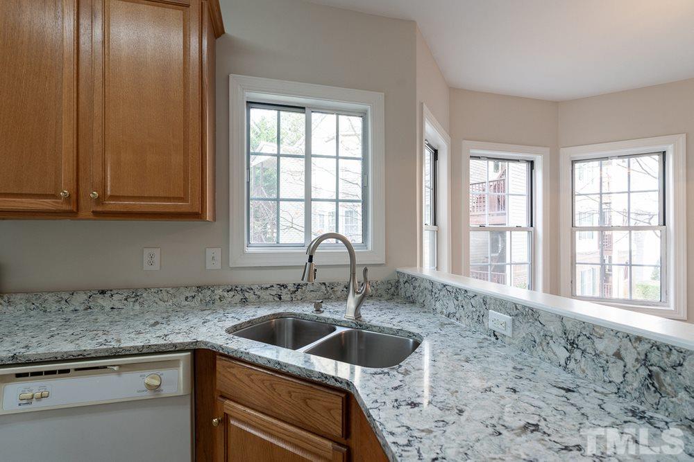 7022 Sandy Forks Road, Unit 201 Raleigh, NC 27615 - Photo 13 of 30 a kitchen with granite countertop a sink and a window