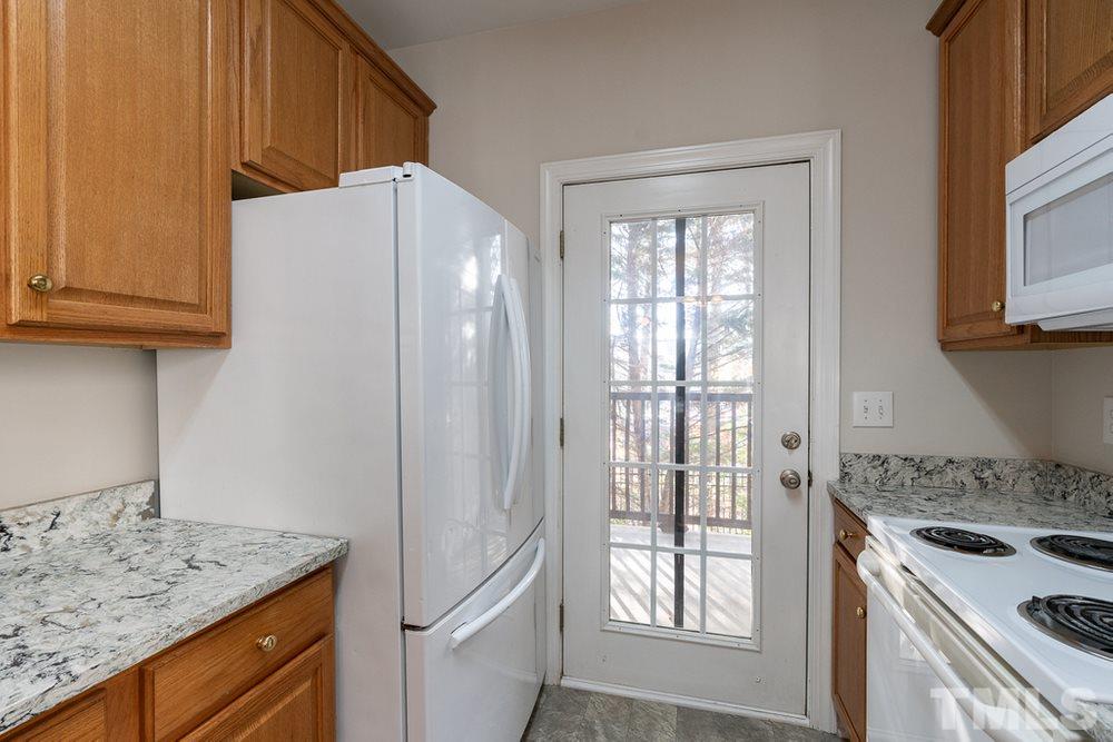 7022 Sandy Forks Road, Unit 201 Raleigh, NC 27615 - Photo 14 of 30 a kitchen with a stove a sink and a refrigerator