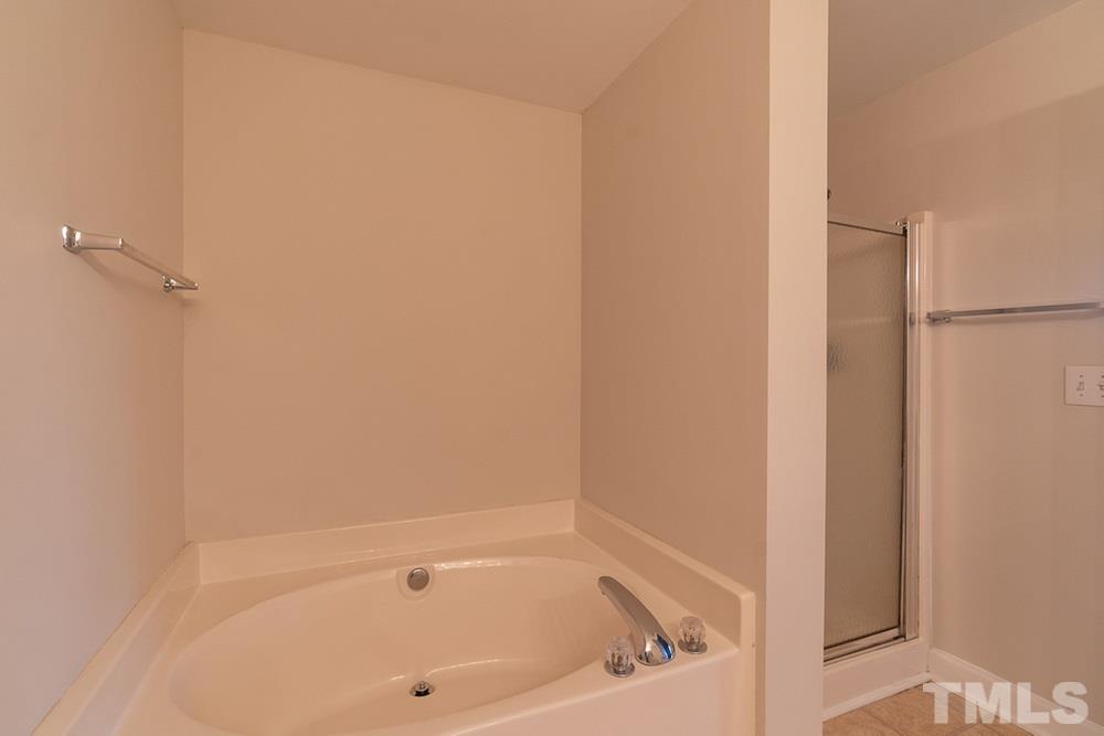 7022 Sandy Forks Road, Unit 201 Raleigh, NC 27615 - Photo 20 of 30 a bathroom with a bathtub
