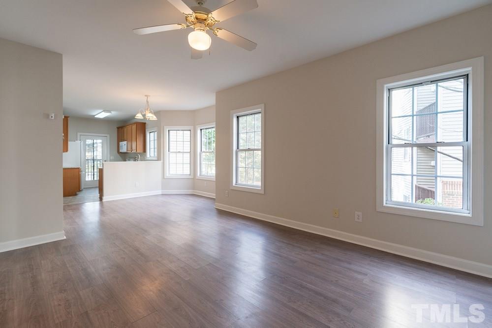 7022 Sandy Forks Road, Unit 201 Raleigh, NC 27615 - Photo 3 of 30 a view of an empty room with a window and wooden floor