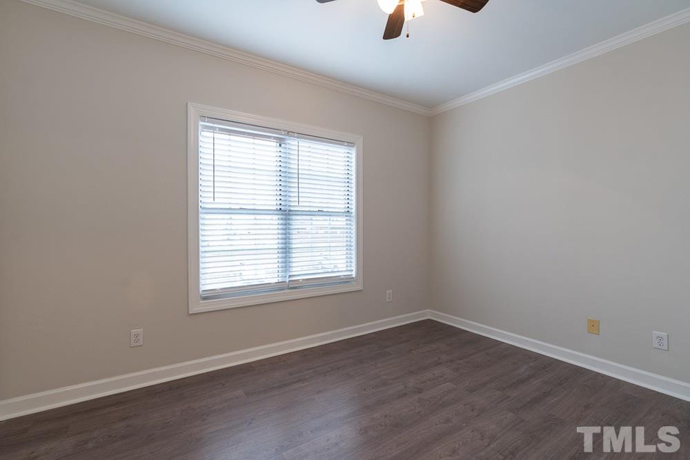 7022 Sandy Forks Road, Unit 201 Raleigh, NC 27615 - Photo 22 of 30 an empty room with a window and a ceiling fan