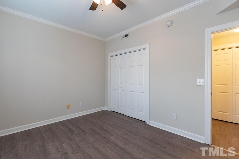 7022 Sandy Forks Road, Unit 201 Raleigh, NC 27615 - Photo 23 of 30 an empty room with a window and wooden floor