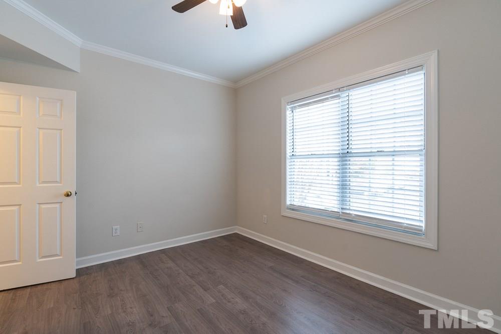 7022 Sandy Forks Road, Unit 201 Raleigh, NC 27615 - Photo 25 of 30 a view of an empty room with wooden floor and a window