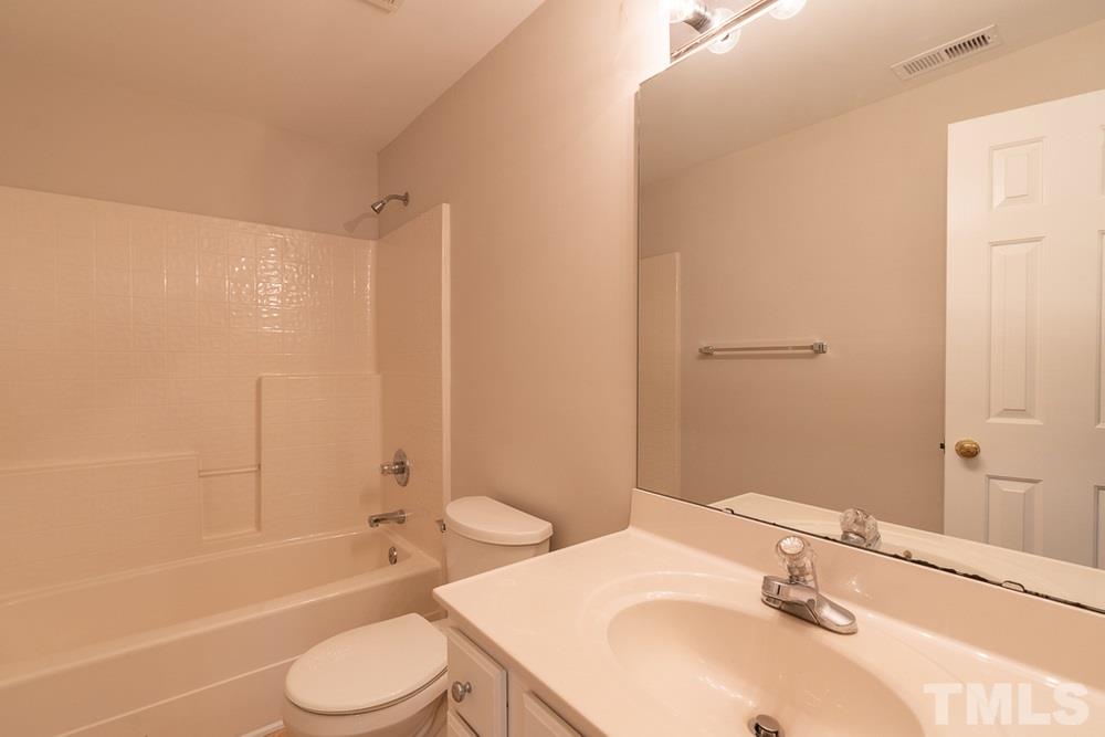 7022 Sandy Forks Road, Unit 201 Raleigh, NC 27615 - Photo 26 of 30 a bathroom with a sink toilet and shower