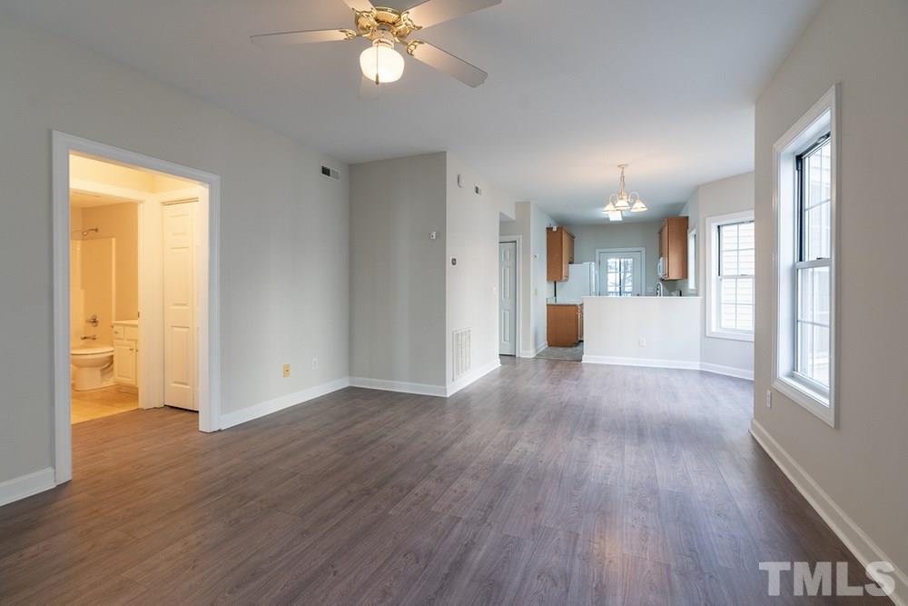 7022 Sandy Forks Road, Unit 201 Raleigh, NC 27615 - Photo 4 of 30 a view of a big room with wooden floor and a window