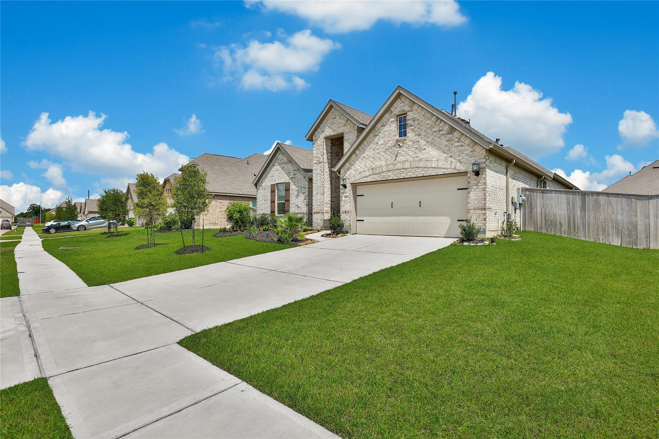 3707 Meadow Breeze Lane Rosenberg, TX 77469 - Photo 11 of 30 a view of a white house next to a yard with big trees