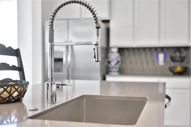 a view of a kitchen with a sink and cabinets