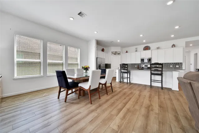 a view of a dining room with furniture window and wooden floor