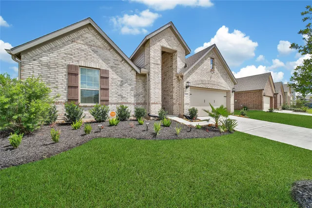 a front view of a house with a yard and porch