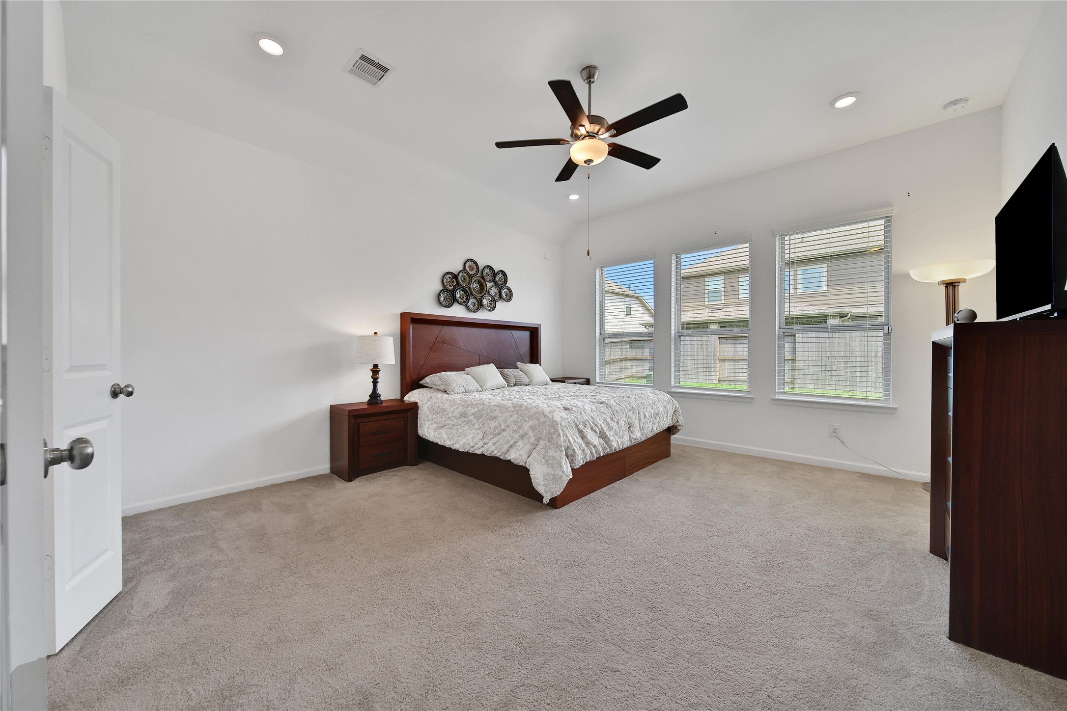 3707 Meadow Breeze Lane Rosenberg, TX 77469 - Photo 21 of 30 a bedroom with a bed and a flat screen tv