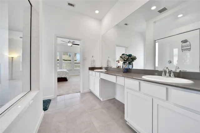a bathroom with a sink double vanity and a mirror