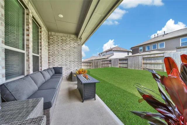 a balcony with furniture and a yard
