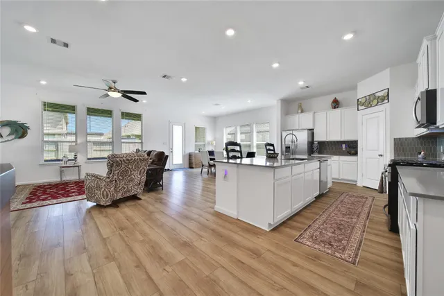 a living room with furniture and a wooden floor