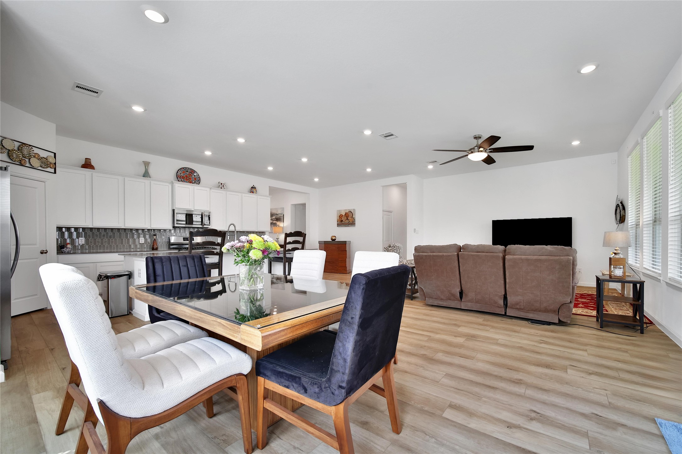 3707 Meadow Breeze Lane Rosenberg, TX 77469 - Photo 7 of 30 a living room with furniture and a dining table with wooden floor