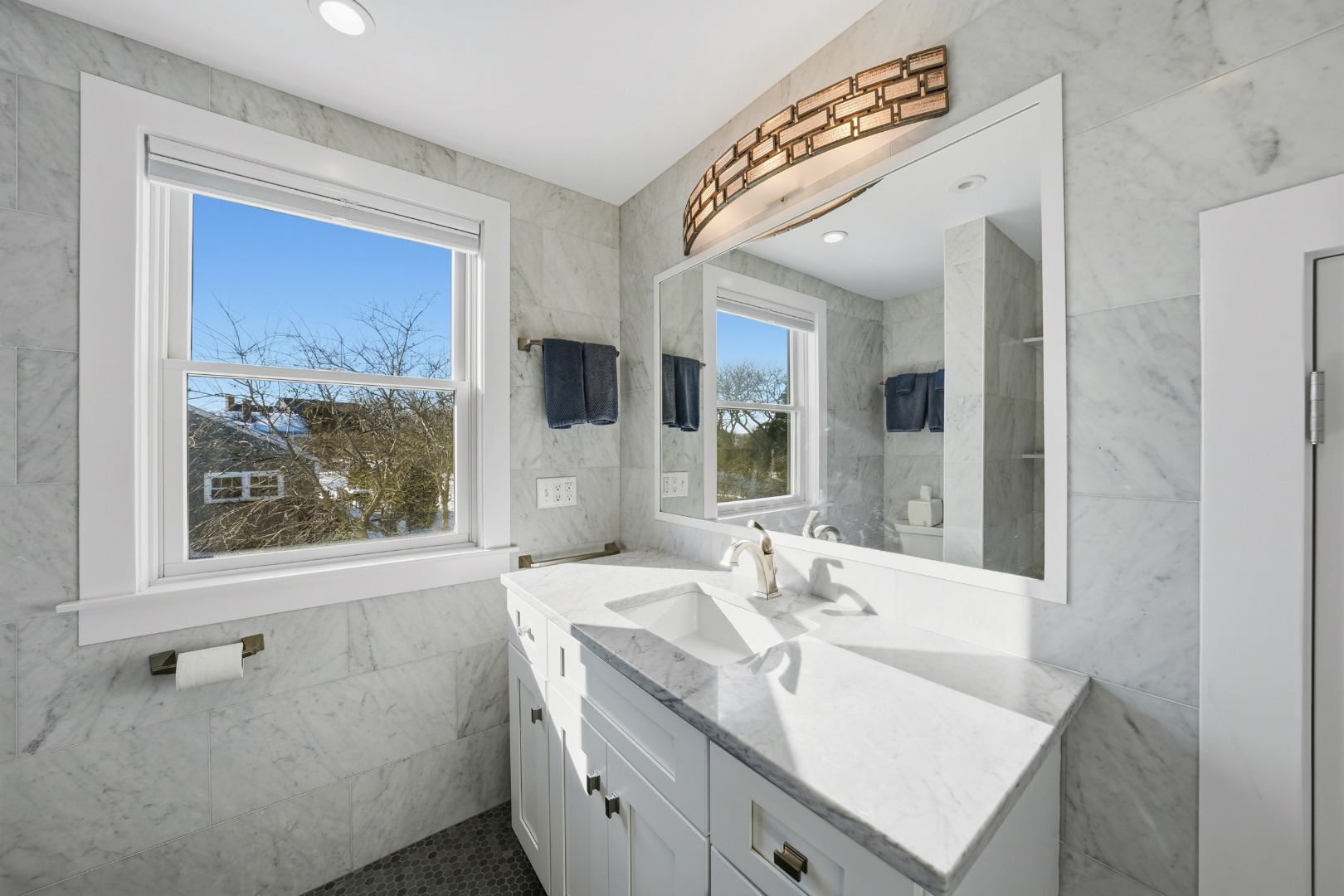 10 Pilgrim Road Nantucket, MA 02554 - Photo 44 of 65 a bathroom with a sink and a mirror