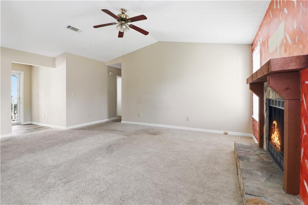 5288 Biffle Downs Road Stone Mountain, GA 30088 - Photo 6 of 18 a view of an empty room with a fireplace