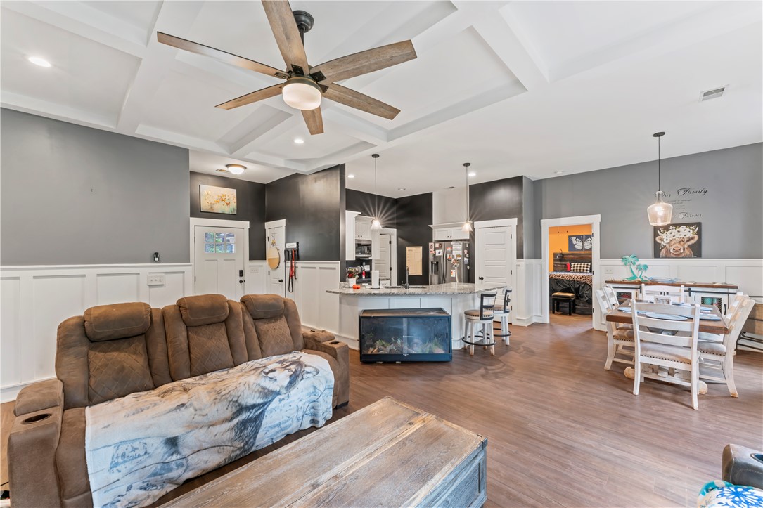 429 Nelson Drive Anderson, SC 29621 - Photo 31 of 32 An open floorplan seamlessly connects the living area, kitchen, and dining space, all crowned by a decorative coffered ceiling.