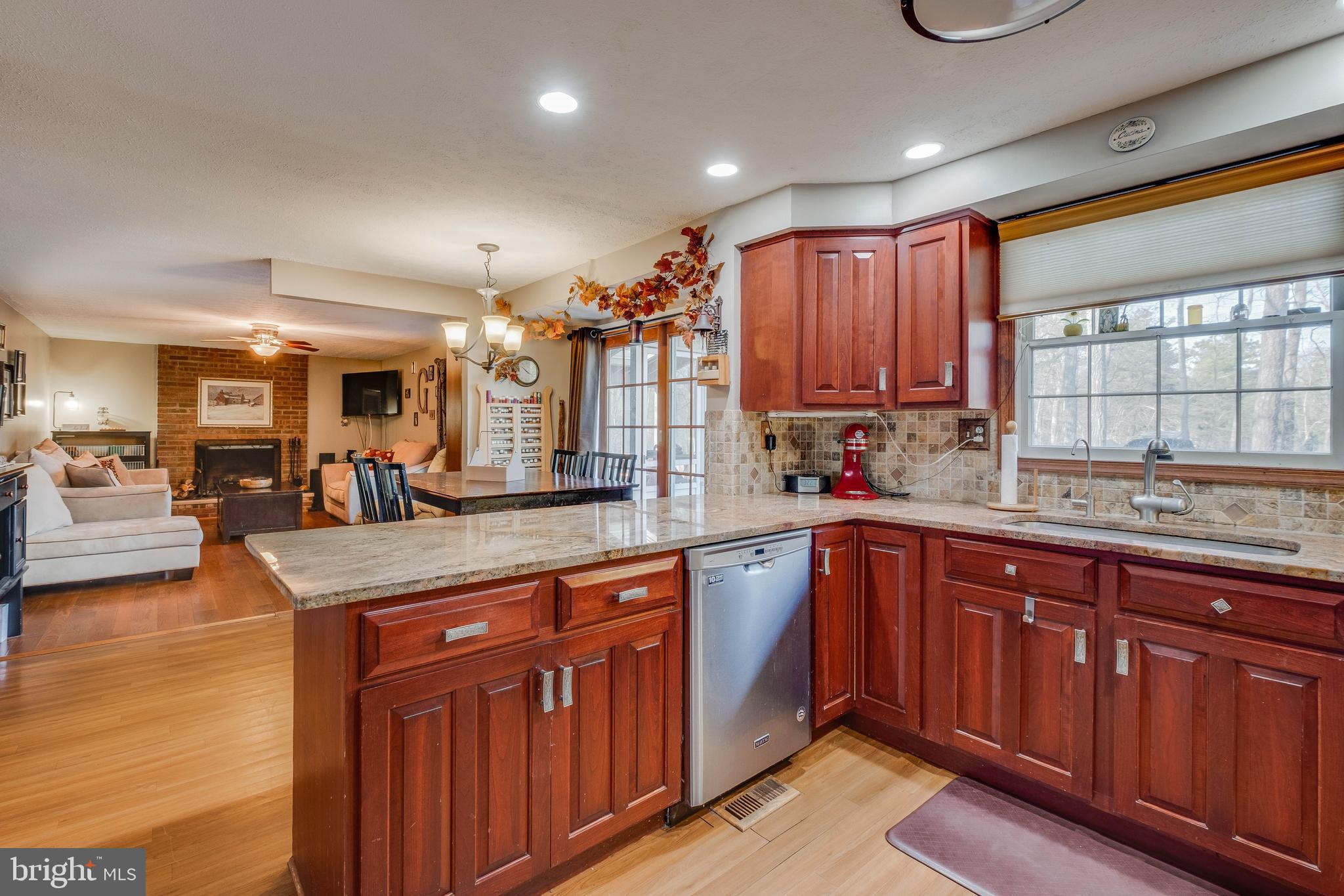 572 Fairview Road Medford, NJ 08055 - Photo 11 of 48 a kitchen with stainless steel appliances granite countertop wooden cabinets a sink and dishwasher a refrigerator with wooden floors