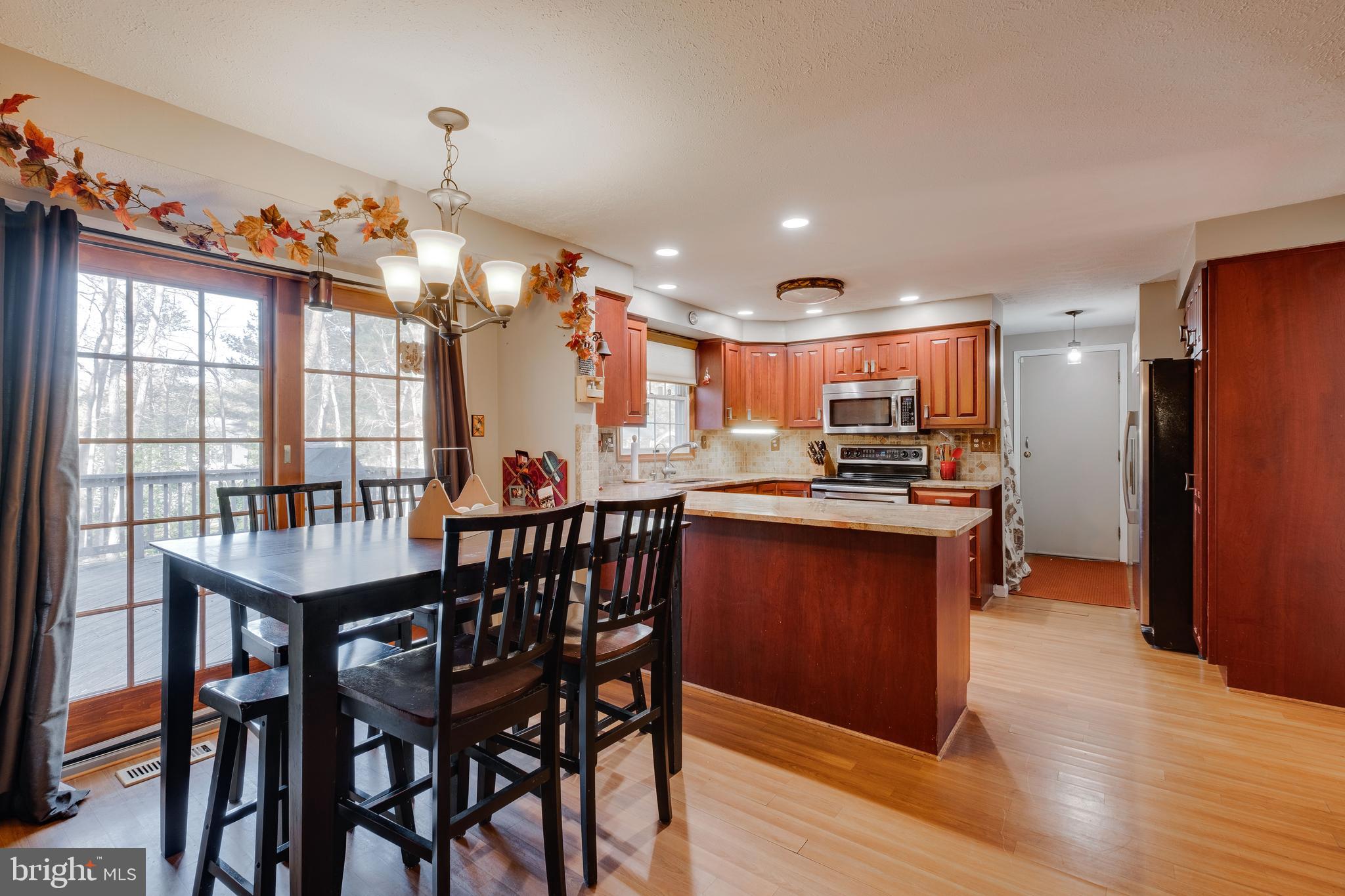 572 Fairview Road Medford, NJ 08055 - Photo 12 of 48 a open kitchen with stainless steel appliances granite countertop a refrigerator dining table and chairs
