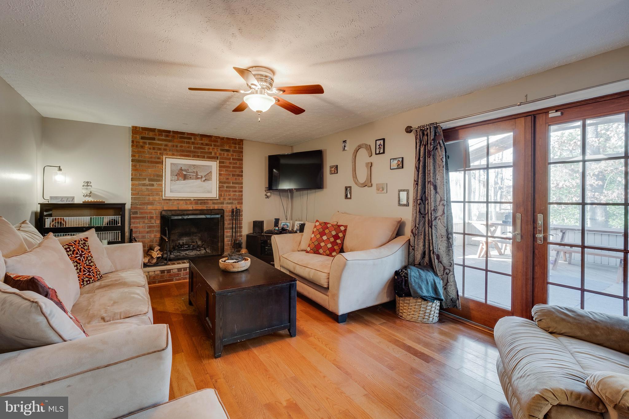 572 Fairview Road Medford, NJ 08055 - Photo 14 of 48 a living room with furniture a large window and a fireplace