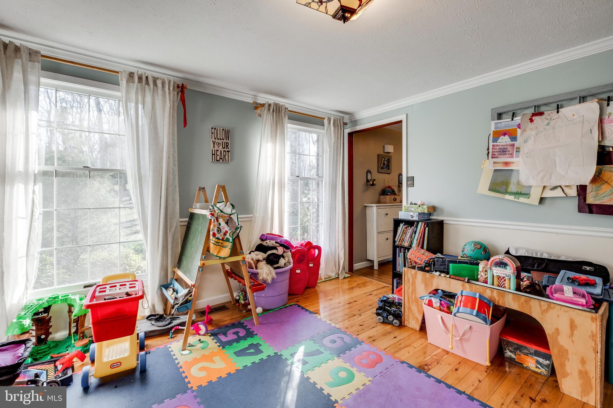 572 Fairview Road Medford, NJ 08055 - Photo 18 of 48 a living room with lots of baby toys