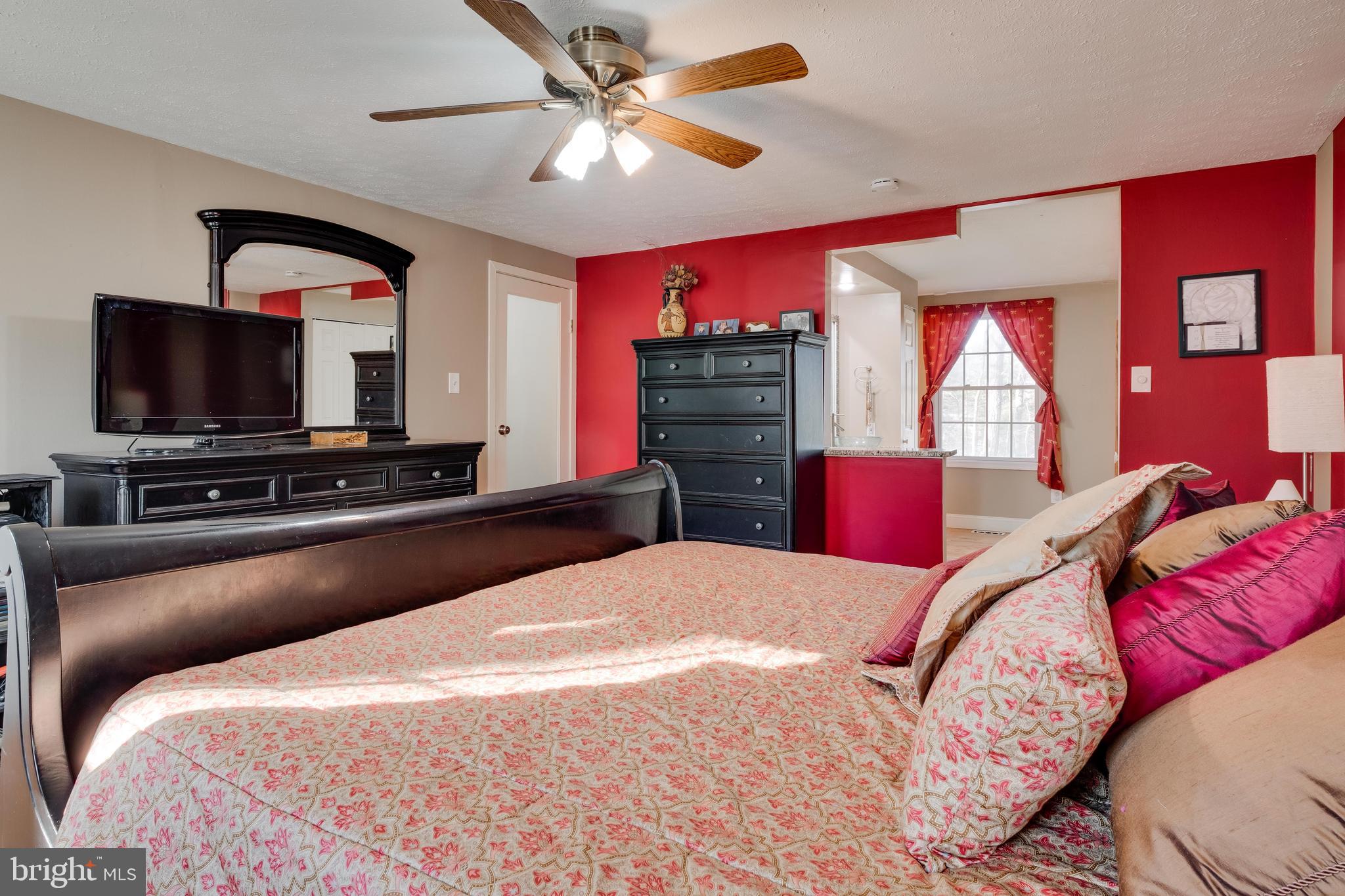 572 Fairview Road Medford, NJ 08055 - Photo 23 of 48 a bed room with a bed a television and dresser