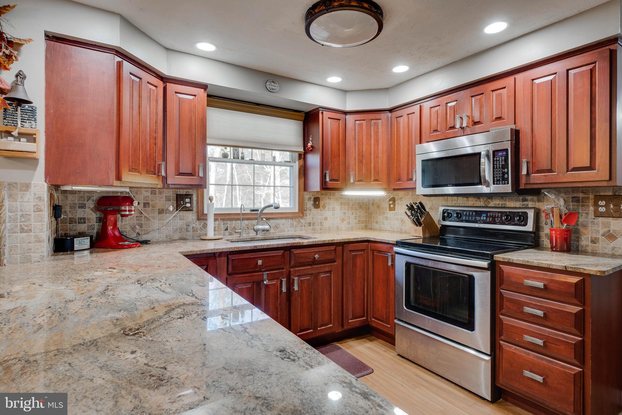 572 Fairview Road Medford, NJ 08055 - Photo 9 of 48 a kitchen with stainless steel appliances granite countertop a stove sink microwave and window