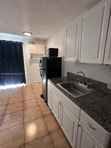 a kitchen with a sink a stove and refrigerator