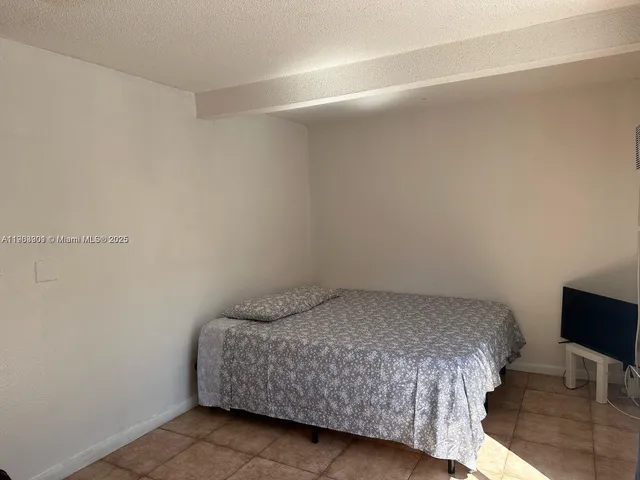 a bedroom with a bed and chair