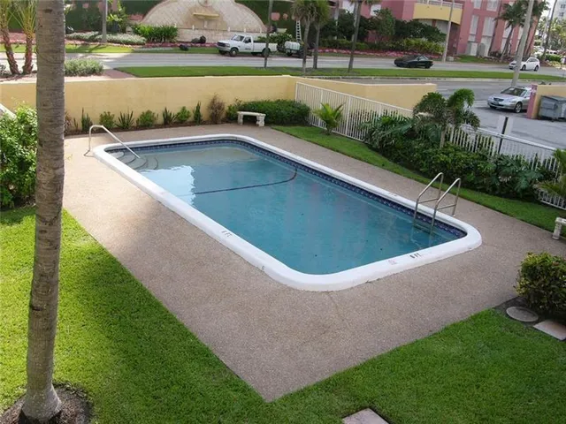 a view of a swimming pool and a yard