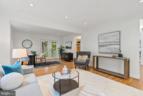 a living room with furniture a fireplace and a table