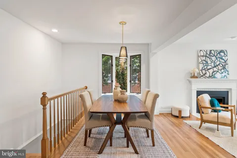 a kitchen with granite countertop a stove a sink a refrigerator and wooden cabinets